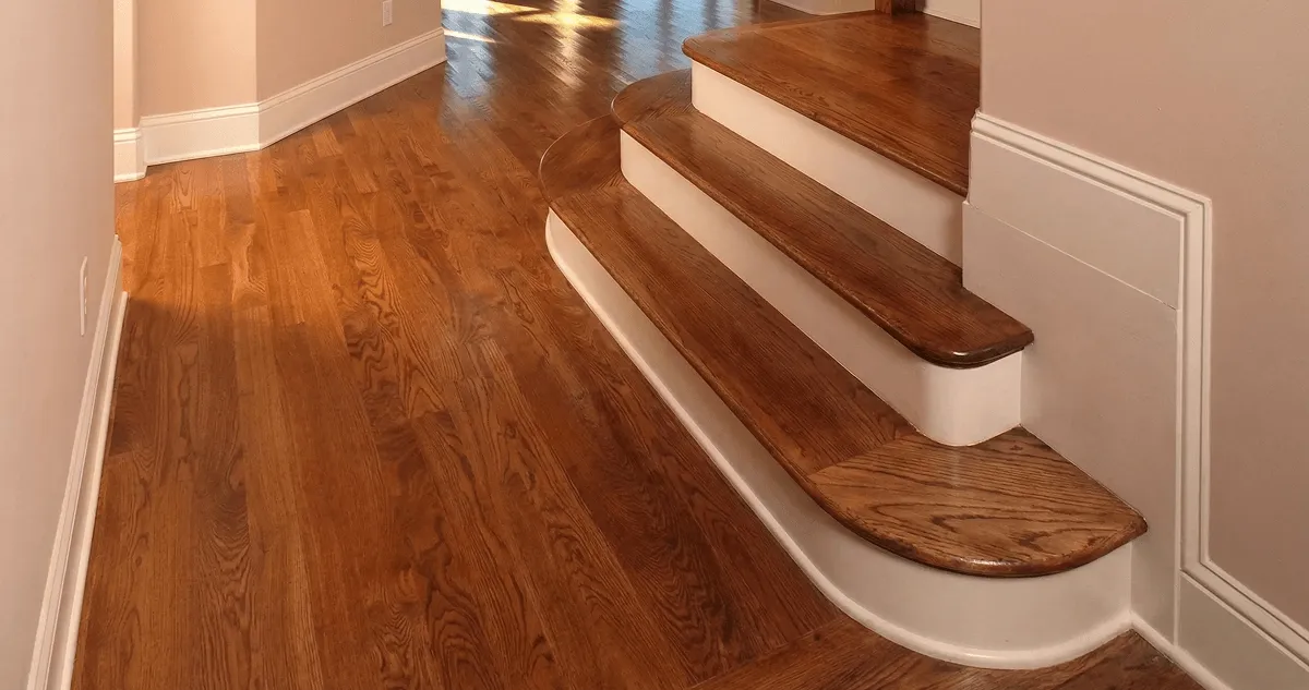 Base floor of a staircase with professionally restored wood flooring in Irvine CA