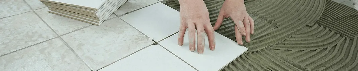 Professional installing white tile floors in Irvine, CA